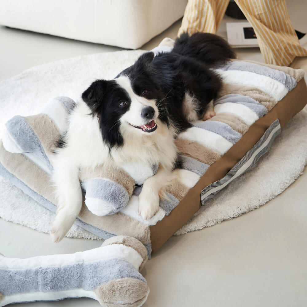 Cama calmante de pelúcia listrada Deluxe para cachorro com travesseiro